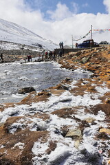 zero point, a popular tourist destination in north sikkim surrounded by snowcapped mountains, mountain stream flowing through the alpine valley, india