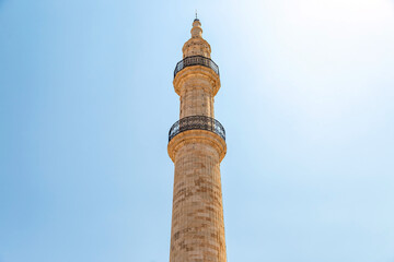 Fototapeta na wymiar Neratze Mosque iconic Minaret at Rethymno city, Crete island, Greece. Under view of Islamic monument