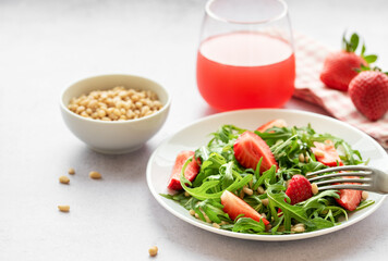 Fresh Strawberry Arugula Salad With Pine Nuts Served on a Bright Day