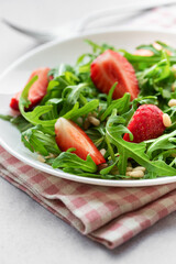 Fresh Strawberry Arugula Salad With Pine Nuts Served on a Bright Day