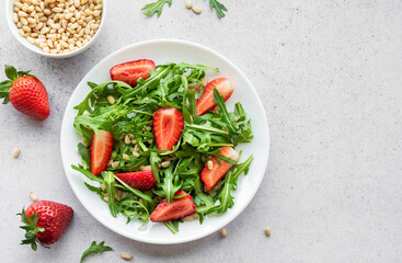 Fresh Strawberry Arugula Salad With Pine Nuts Served on a Bright Day