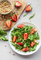 Fresh Strawberry Arugula Salad With Pine Nuts Served on a Bright Day