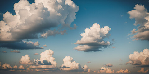 Blue sky background with fluffy white clouds on a sunny day