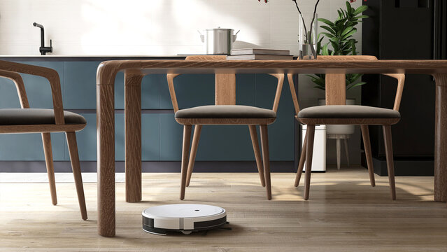 White modern vacuum cleaner robot vacuuming, cleaning wooden laminated parquet floor under table in teal blue dining room in sunlight for housework, smart home lifestyle, technology background 3D