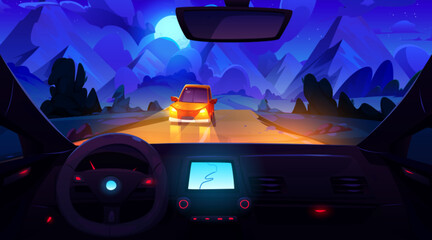 Obraz premium Night mountain view from inside car. Vector cartoon illustration of auto riding highway towards rocks, traffic on road illuminated by headlamps, steering wheel, gps navigator on dashboard, moon in sky