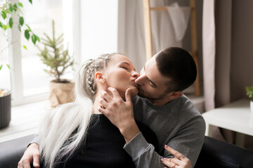 Romantic Couple Sharing a Tender Kiss in a Brightly-Lit room at home, close up shot