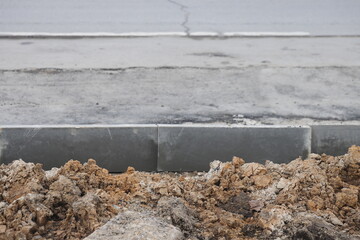 new asphalt road under construction in city, closeup of photo with selective focus