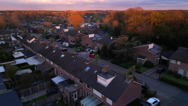 Orange lit tree tops in Dutch brabant Cranendonck village Maarheeze aerial