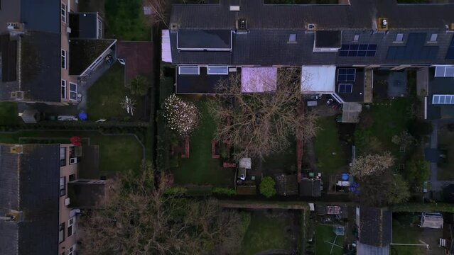Top down view on Dutch suburb with rooftop, houses solar panels and streets