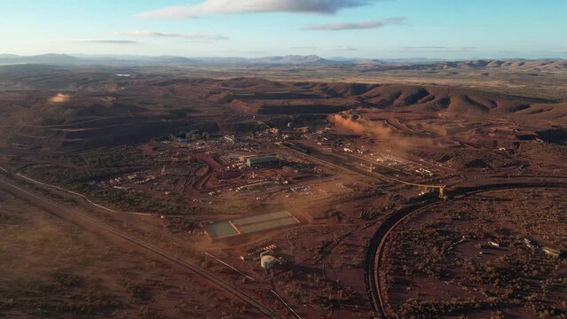 Aerial Establishing shot of Marandoo Iron mine site in Australian desert landscape at sunny day. Mining Industry  in Australia. Wide shot.