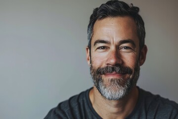 Portrait of a handsome bearded man with gray hair and beard. - obrazy, fototapety, plakaty