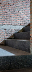 light and shadow in to stairwell on cement stairs case brick wall