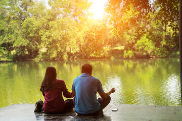 Lover to sit on the terrace near the riverside with sunlight background. Tourist to relax and so happy on holiday.