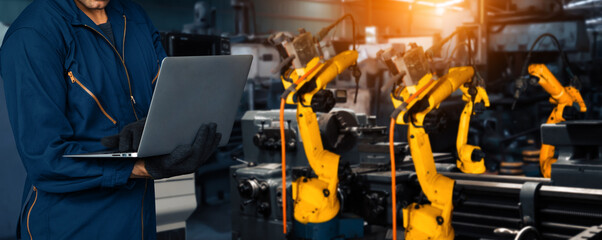 XAI Engineer use advanced robotic software to control industry robot arm in factory. Automation...