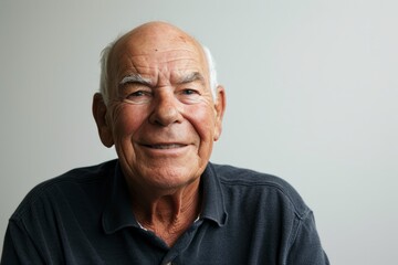 Portrait of a senior man smiling at the camera. Isolated on white background.