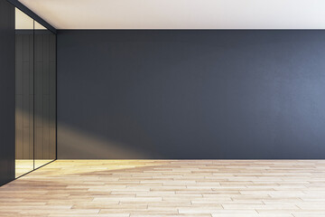 An empty office corridor with wooden flooring, a black wall, and a glass partition, depicting a...