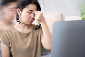 Asian woman suffering from vertigo, dizziness caused by inner ear health problem or high blood pressure concept