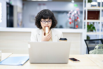 White-collar workers eating late night snacks while working overtime in the office