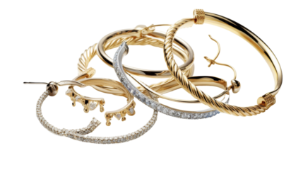 Various types of jewelry laid out on a white background, showcasing different styles and designs
