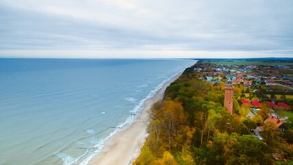 Captured by drone on a cloudy November day, the Gąski lighthouse stands against the somber sky.