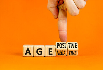 Age positivity or negativity symbol. Concept word Age positivity or Age negativity. Beautiful orange background. Psychologist hand. Psychological age positivity or negativity concept. Copy space.