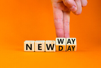 New day and way symbol. Concept word New day New way on beautiful wooden cubes. Beautiful orange table orange background. Businessman hand. Business new day and way concept. Copy space.