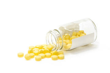 Yellow pills overflowing from the bottle