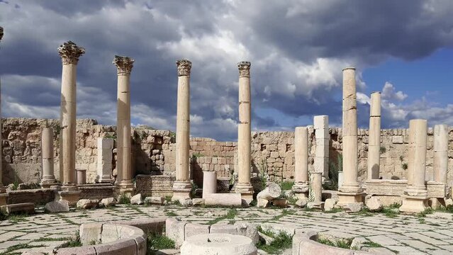 Roman ruins (against the background of a beautiful sky with clouds, 4K, time lapse, with zoom) in the Jordanian city of Jerash (Gerasa of Antiquity), Jordan  