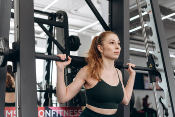 Fototapeta na wymiar woman trains in fitness gym