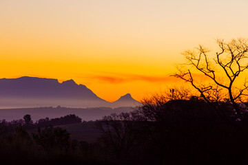 Silhouette of Table Mountain against a dusk sunset sky in Cape Town