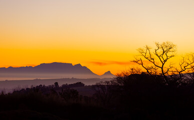 Silhouette of Table Mountain against a dusk sunset sky in Cape Town