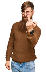 Young irish redhead man wearing casual clothes and glasses showing middle finger, impolite and rude...