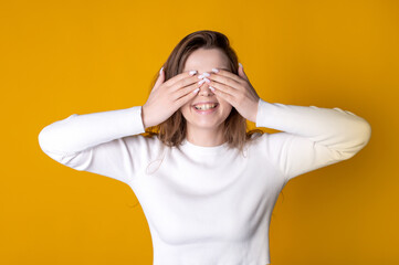 Joyful Woman Covering Eyes with Hands