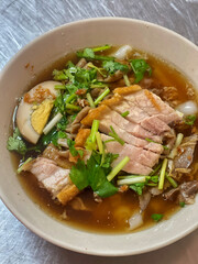 Rolled Rice Noodles in Five-spices Broth, sweet flavor with Chinese spices. The soup is black of stewed water. Ingredients are pork offal, pork blood and boiled egg