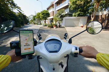 POV of motorbike taxi driver accepting new request - obrazy, fototapety, plakaty