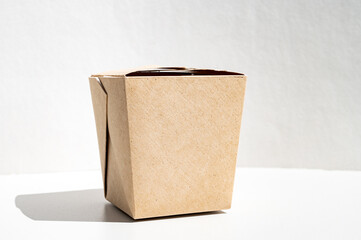 A box of craft cardboard for takeaway food. Closed food container insulated
