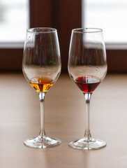 Two glasses of red and white wine on a table in a restaurant