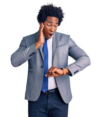 Handsome african american man with afro hair wearing business jacket looking at the watch time...