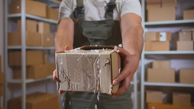a damaged parcel,a broken box, a courier or a mover shows