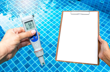 Digital water tester and blank clipboard in girl hand over swimming pool cleaning progress, pool...