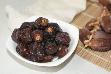 Two type of date fruit, Lulu and Tunisian dates. Lulu type is much smaller and dark compared to the Tunisian type.