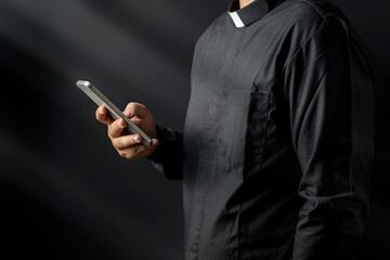 Portrait of a pastor using a mobile phone