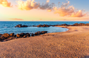 beautiful pink and orange sand beash with black stones and sea surf waves lansacspe with anazing clousy sunset or sunrise sky on background