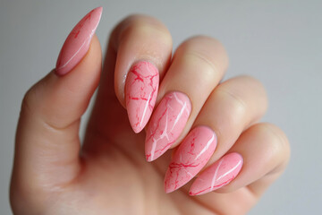 Close-up of pink marble nails with detailed veining, showcasing a sophisticated manicure style