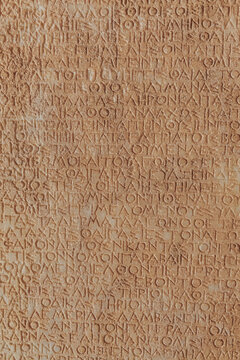 Ancient Roman legal inscriptions (text of Roman imperial law in Ancient Greek language) carved on stone, timeless epigraphic background for historical and educational content. Bodrum, Turkey