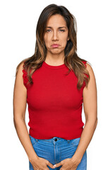 Fototapeta premium Young hispanic woman wearing casual clothes depressed and worry for distress, crying angry and afraid. sad expression.