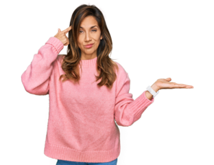 Young hispanic woman wearing casual clothes confused and annoyed with open palm showing copy space and pointing finger to forehead. think about it.
