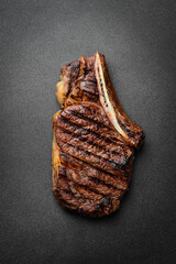 Steak. Grilled steak on the bone. Roasted piece of meat. Free space for text. - 774777251