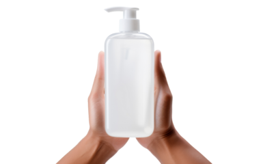 Two hands delicately hold a bottle of soap on a pristine white background