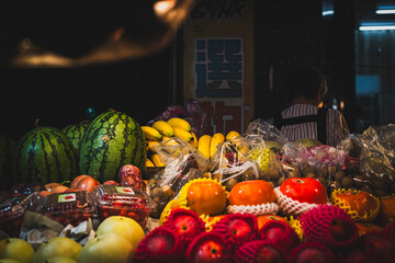 Select best asian tropical fruits. Fruits and vegetables street shop in Taipei during evening....